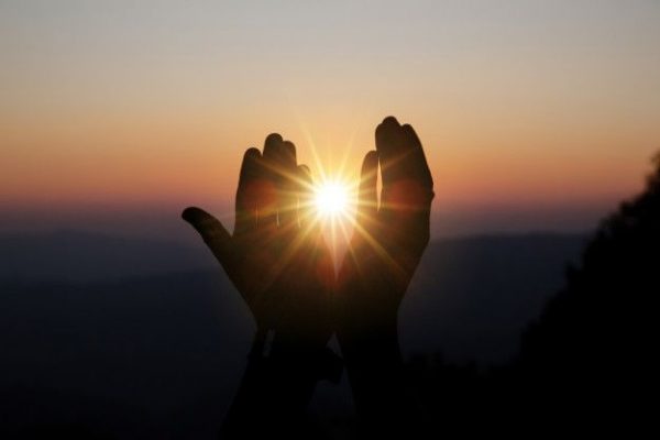 spiritual-prayer-hands-sun-shine-with-blurred-beautiful-sunset_1150-7173